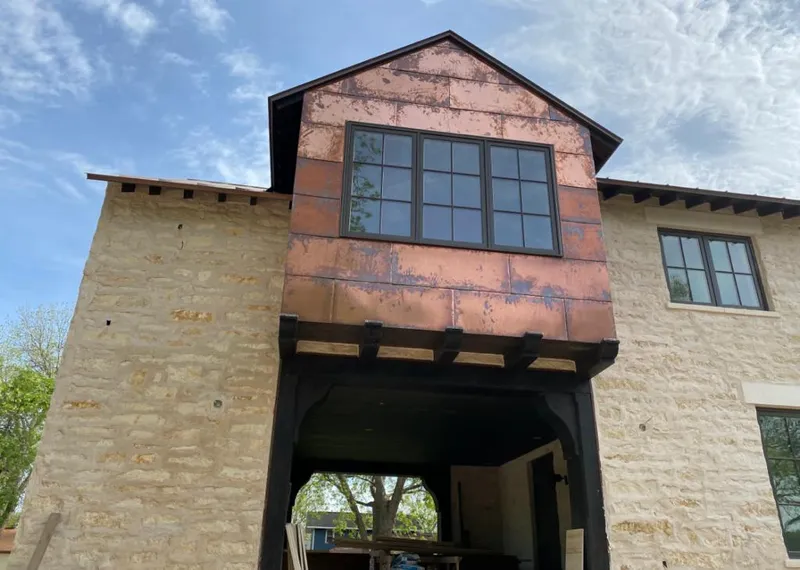 Copper metal panel facade on a stone building for Skylight Installation in Sauk Village