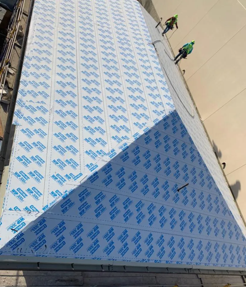 Professional roofers installing underlayment on a metal roof in Sauk Village